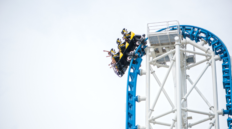 Riders at the top of a roller coaster