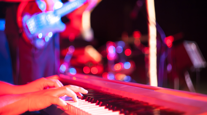 Musician playing on electric keyboard at jazz music festival